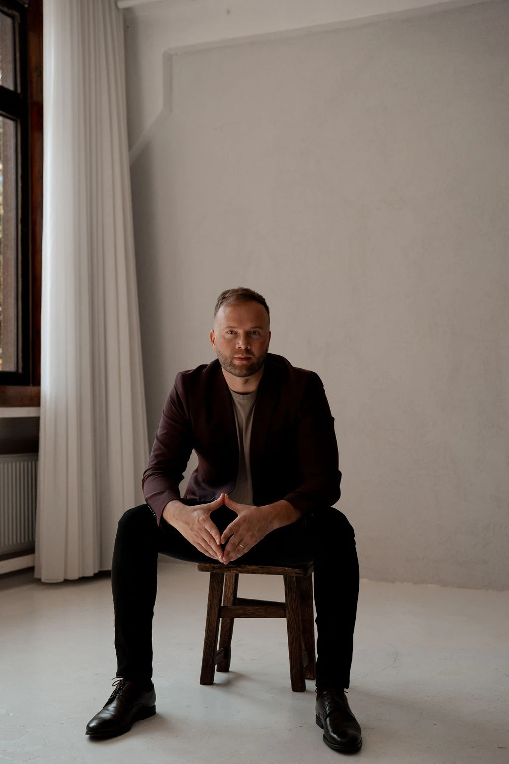 Martin Palmet seated in a softly lit studio